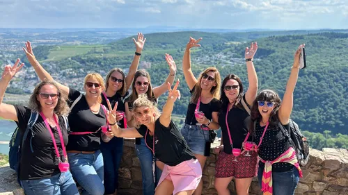 Group of women cheering at scenic viewpoint.