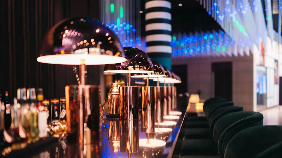 Elegant bar with modern lamps and bottles.