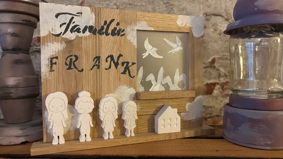 Wooden family plaque with figurines and lantern.