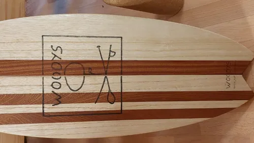 Wooden balance board on wooden floor.