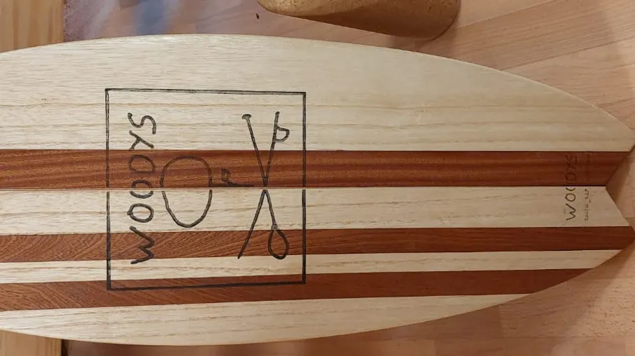 Wooden balance board on wooden floor.