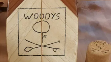 Wooden balance board on wooden surface.