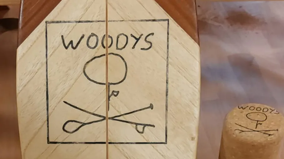 Wooden balance board on wooden surface.