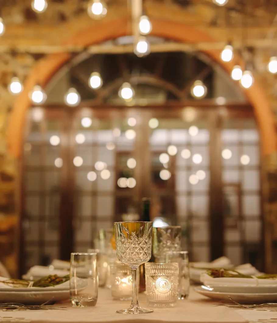 Elegant dining table with glasses and candles.