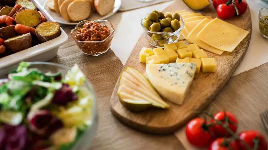 Cheese platter with olives and tomatoes.