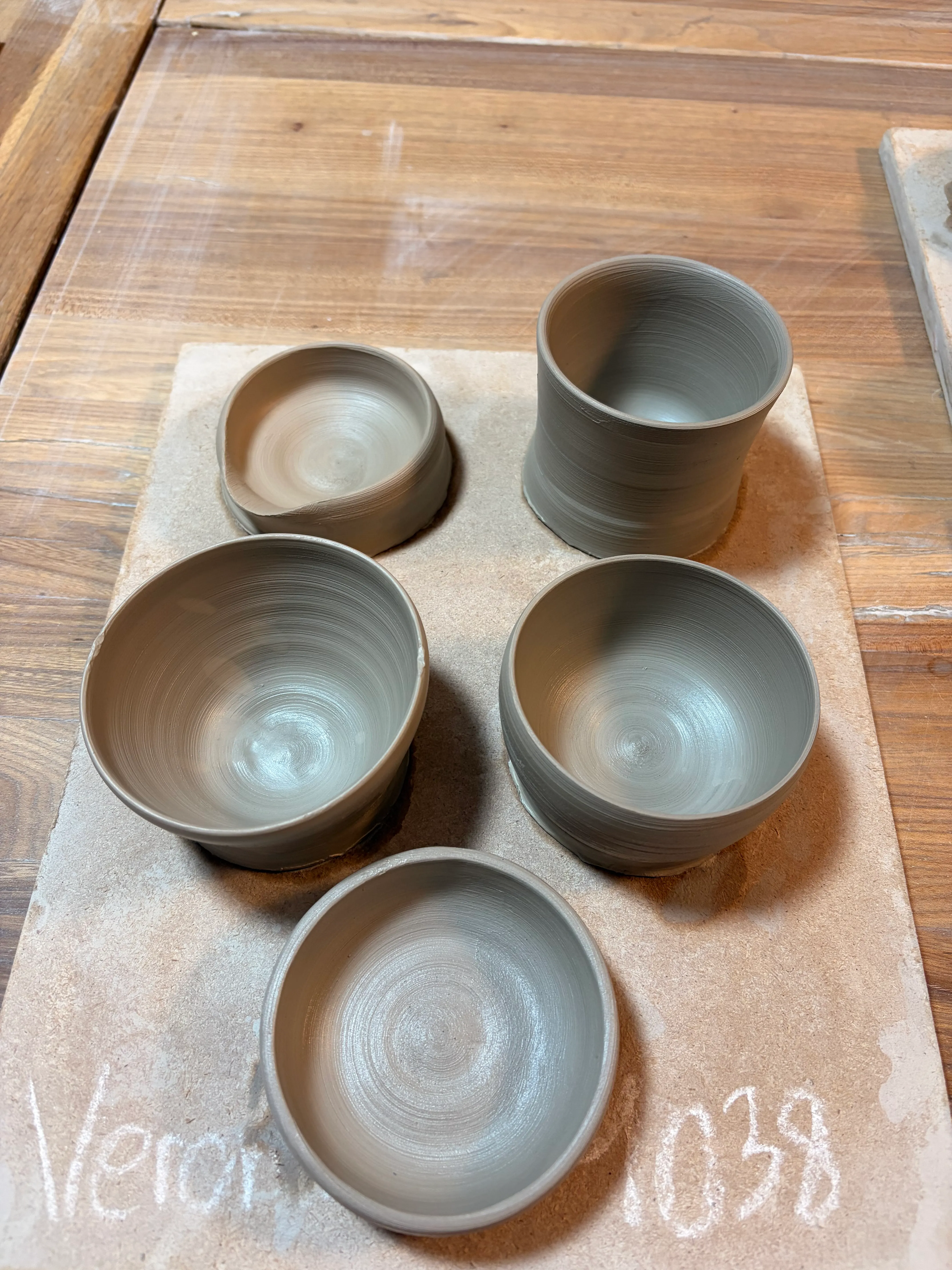Clay pottery bowls on wooden table.