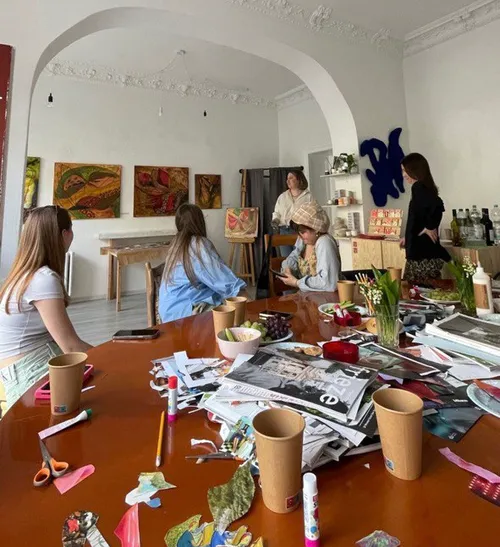 People crafting at a table in art studio.