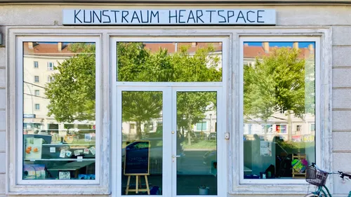Art gallery entrance with glass doors and windows.