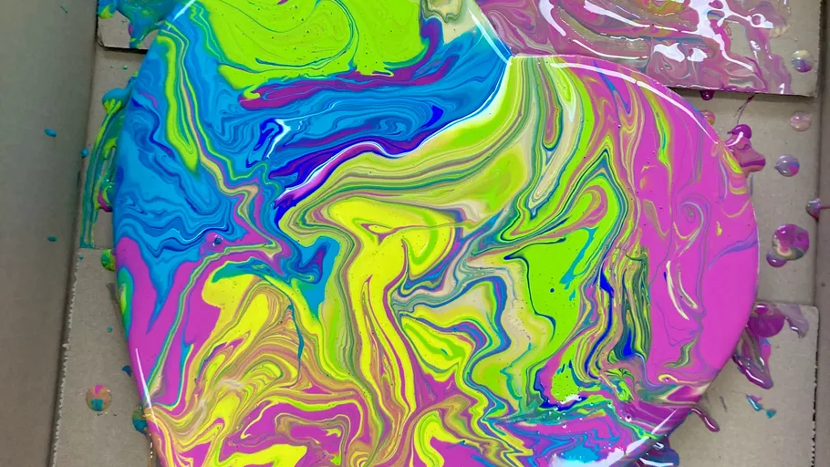 Colorful swirl paint on a heart-shaped canvas.