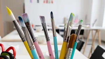 Colorful paintbrushes in an art studio.