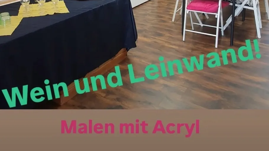 Table set with glasses, chairs around.