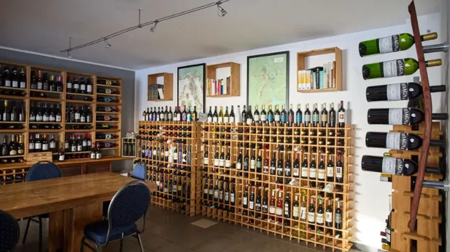 Wine bottles on shelves in a tasting room.