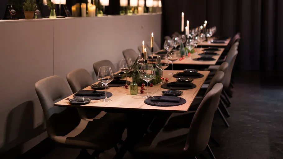 Elegant dinner table set with candles and decor.