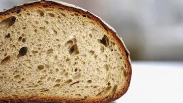 Sliced bread with airy texture, close view.