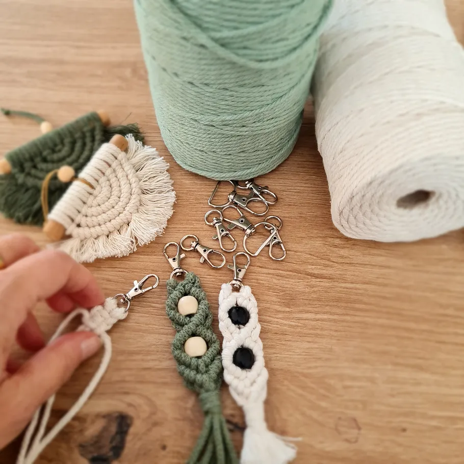 Macrame keychains with crochet supplies on table.