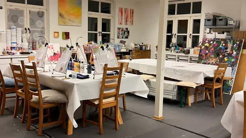 Art studio with tables and paintings.