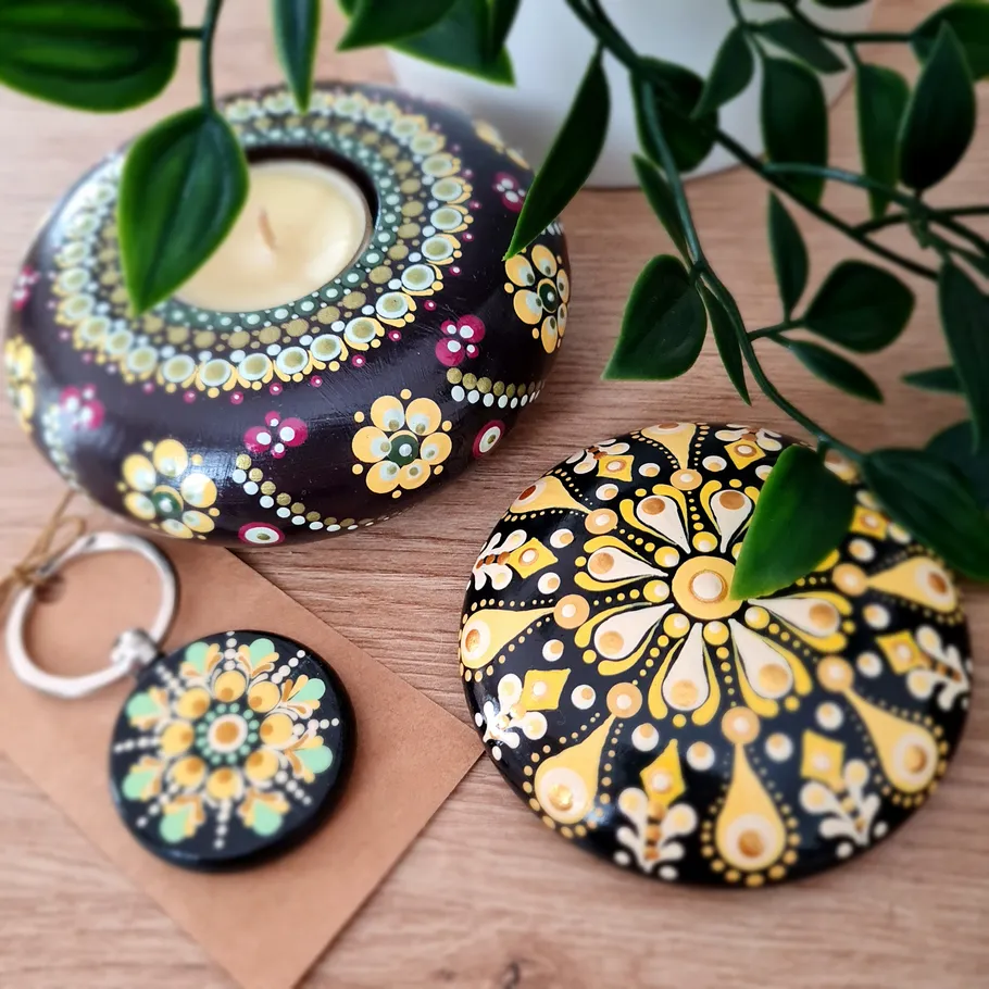 Colorful painted stones and keychain on table.