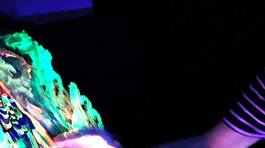 Colorful painting illuminated under black light.