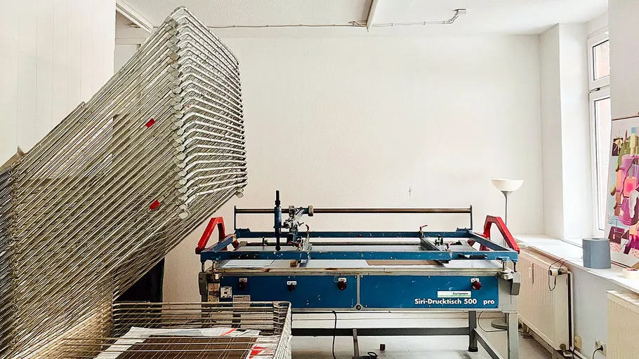 Screen printing machine in a white room.