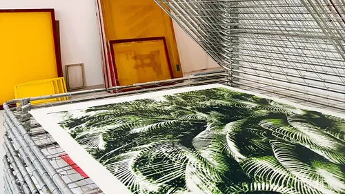Drying rack with print in art studio.