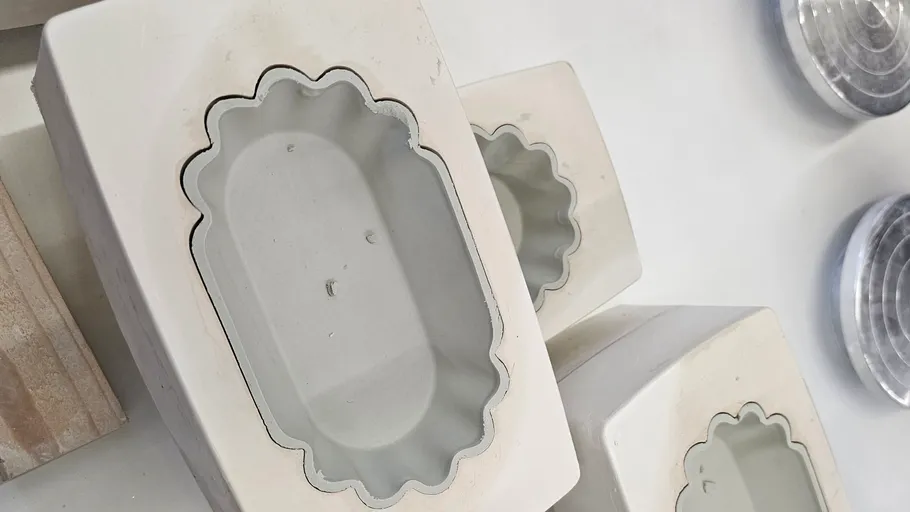 Clay molds stacked on a table.