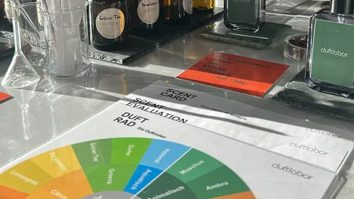 Perfume bottles on a table with scent card.