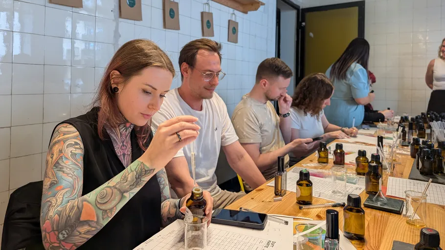 People creating perfumes in a workshop setting.