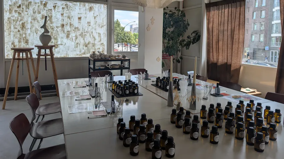 Room with tables, filled with bottles, and chairs.