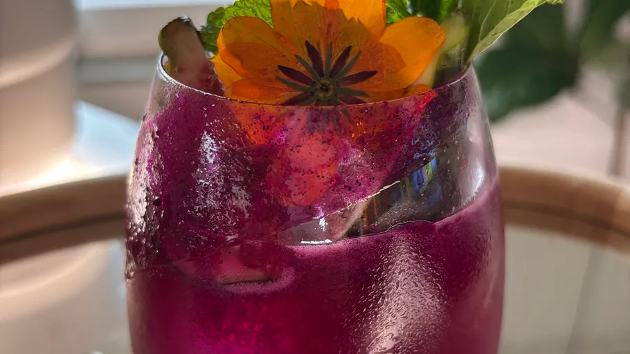 Purple drink with orange flower decoration.
