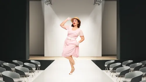 Woman in vintage dress posing on runway.