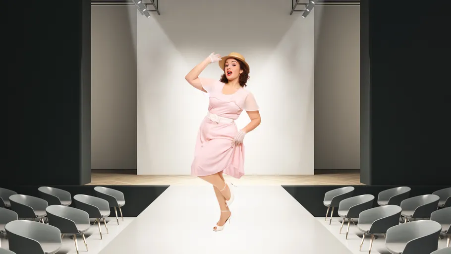 Woman in vintage dress posing on runway.