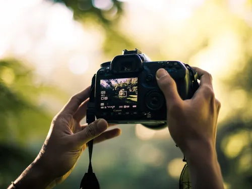 Camera is held outdoors by a person.