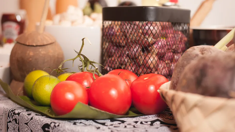 Tomatoes and limes on a table display.
