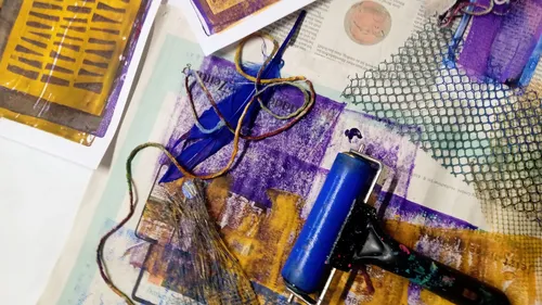 Art supplies with roller, nets, and paper.