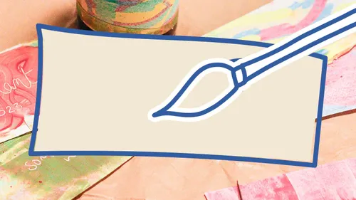 Paintbrush on blank canvas with colorful papers.