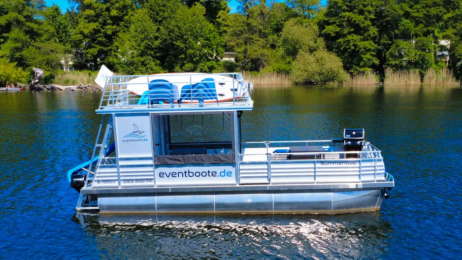 Floating event boat on a tranquil lake.