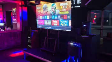 TV displaying NFL game in a bar.