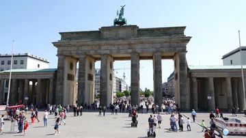 Brandenburg Gate with tourists in Berlin.