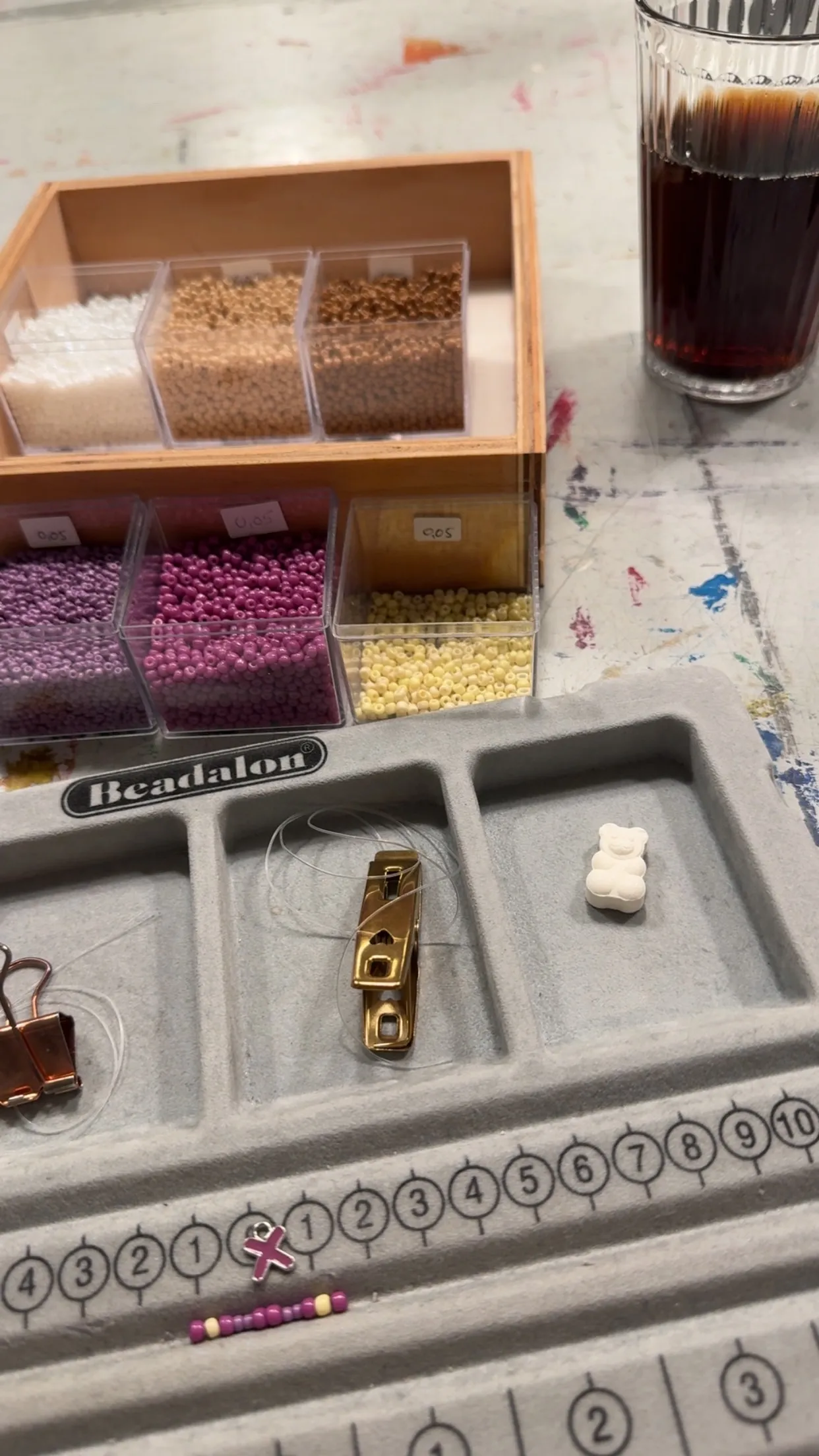 Bead organizer with beads and small bear.