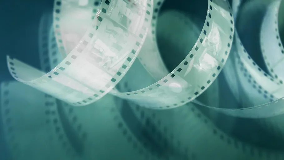 Curved photographic film against gradient background.