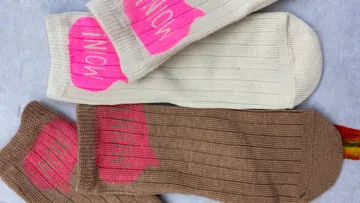 Two pairs of socks, pink word art.