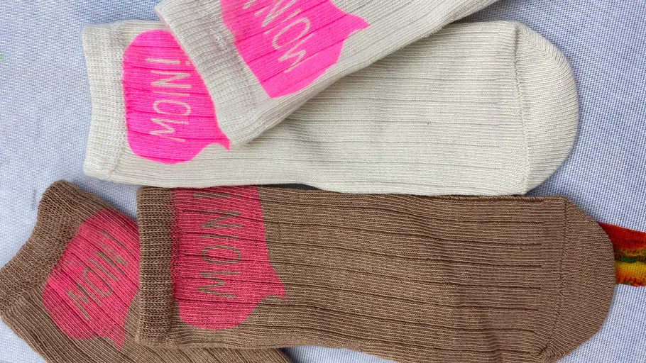 Zwei Paar Socken, pinke Wortkunst.