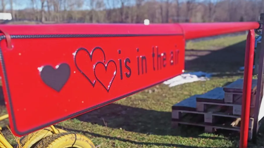 Red barrier with 'Love is in the air' text.