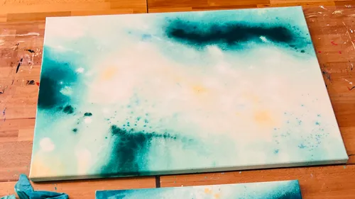 Abstract watercolor painting on wooden table.