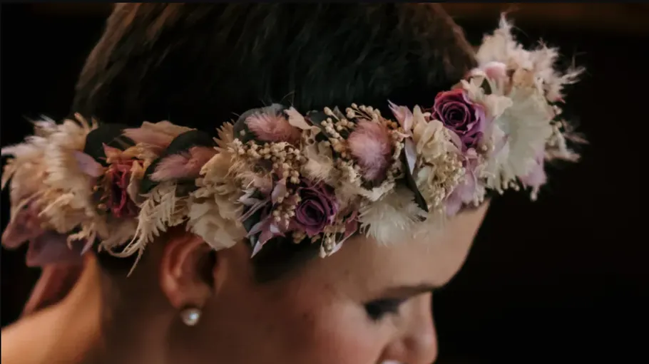 Floral crown adorns person's head.