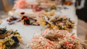 Colorful dried flower wreaths on a table.