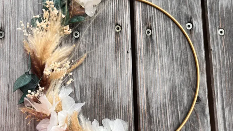 Floral wreath on wooden background.