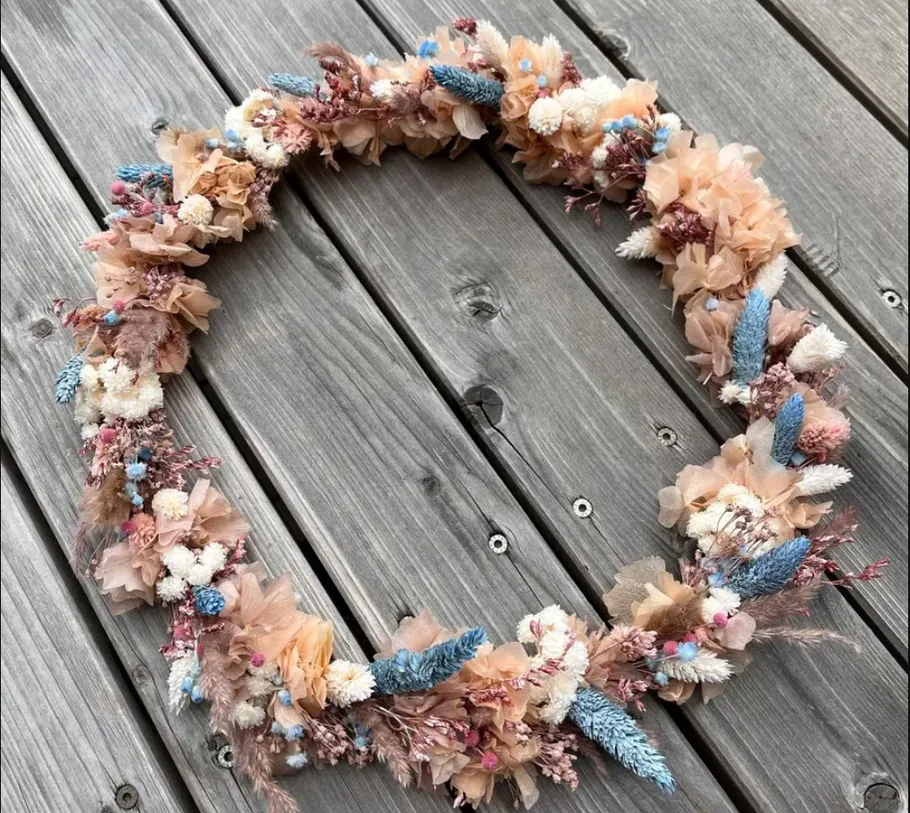 Floral wreath on wooden surface.
