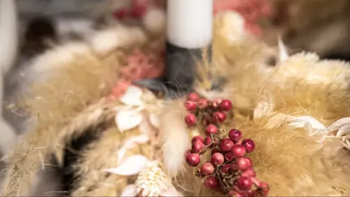 Red berries and pampas grass centerpiece decor.