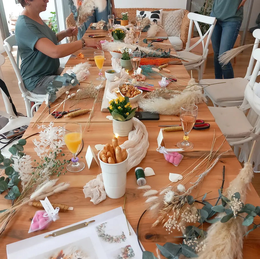 People crafting floral arrangements at a table.